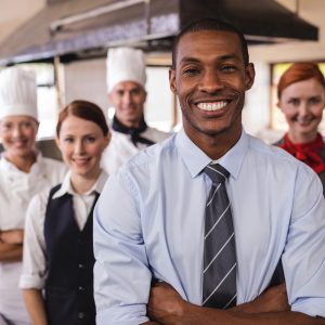 Meal delivery business owner with kitchen staff